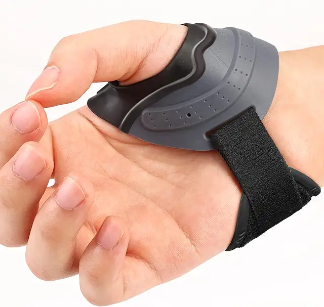 Hand wearing a black and gray ergonomic thumb splint providing thumb arthritis support and stabilization for CMC joint pain relief.