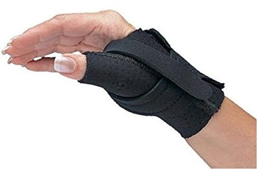Hand wearing a soft black brace providing thumb arthritis support and stabilization for joint pain relief.